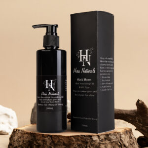 Bottle of Black Bloom Hair Nourishing Oil by Hira Naturals placed on a clean background, showcasing herbal ingredients for strengthening and shine.