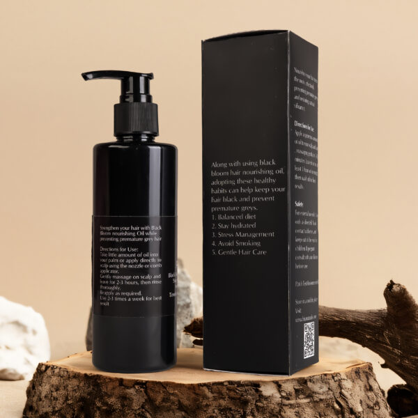 Bottle of Black Bloom Hair Nourishing Oil by Hira Naturals placed on a clean background, showcasing herbal ingredients for strengthening and shine.